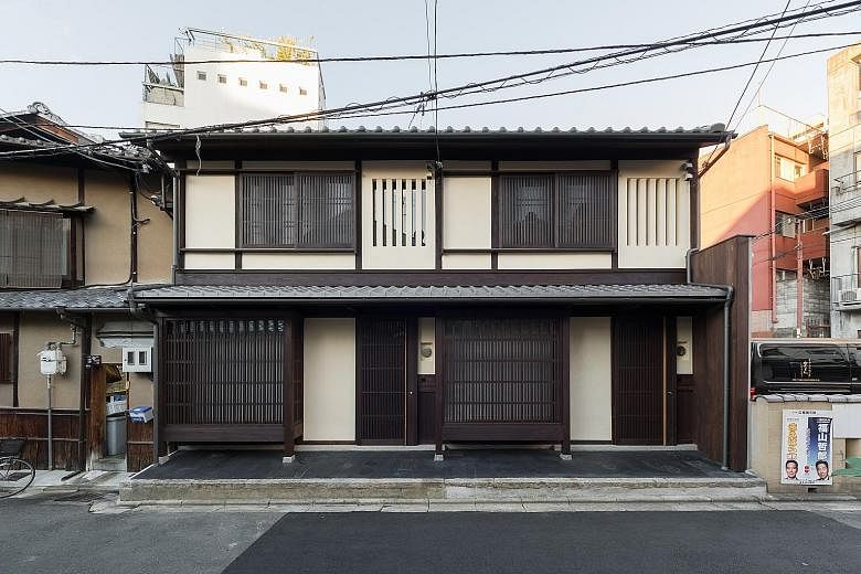 The two traditional townhouses. The living area, kitchenette and a garden on the ground floor of BenTen East, one of the two restored townhouses.