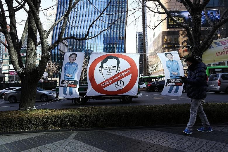 A placard outside the Samsung office features a cartoon in the likeness of Mr Lee Jae Yong. Many Koreans fear that Samsung's troubles would hurt the national economy.