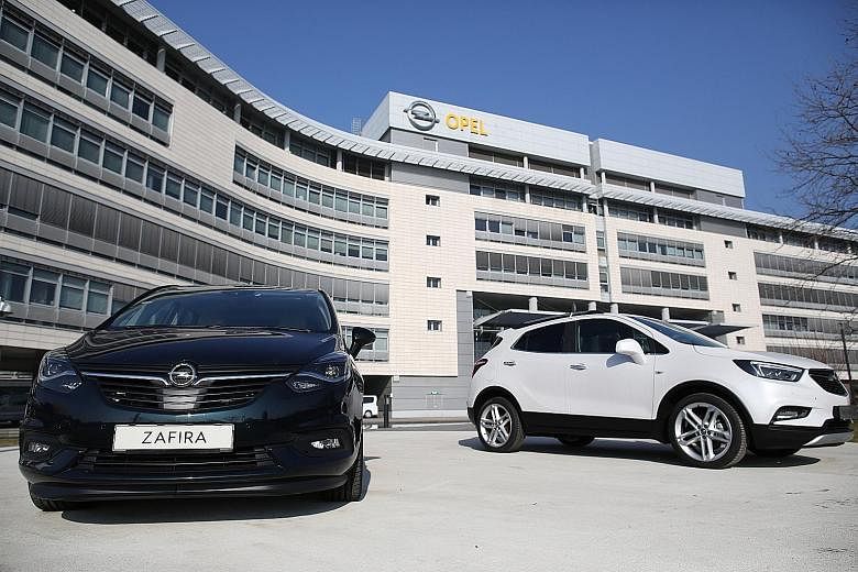 An Opel Zafira (left) and an Opel Mokka X SUV at the automaker's HQ in Ruesselsheim, Germany.