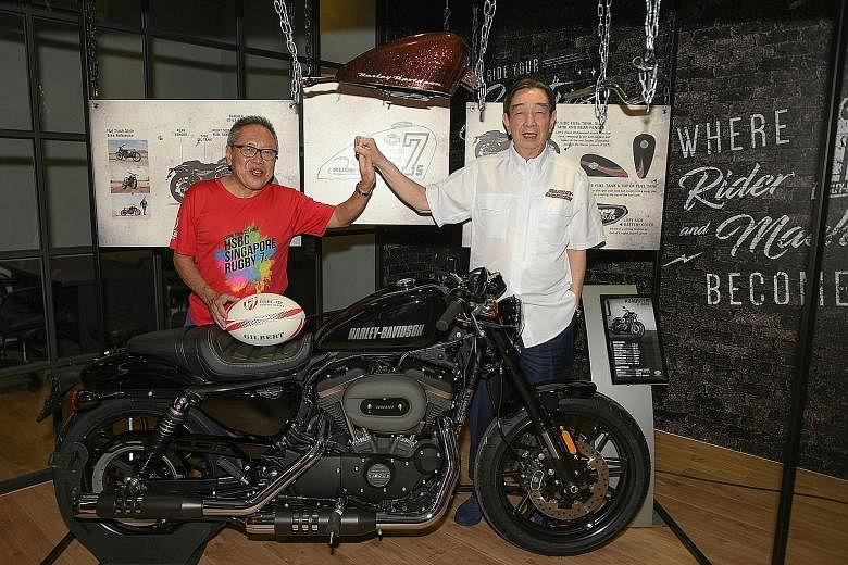 Rugby Singapore chairman Low Teo Ping (left) and Komoco Motorcycles managing director Teo Hock Seng, friends for 53 years, with a Harley- Davidson Roadster worth $39,000 that one Singapore 7s ticket holder will win.