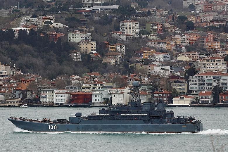 A Russian Navy ship on the Bosphorus Strait heads towards the Black Sea. A Nato official said Nato's move to bolster its naval presence in the Black Sea was to counter Russia's military build-up there.