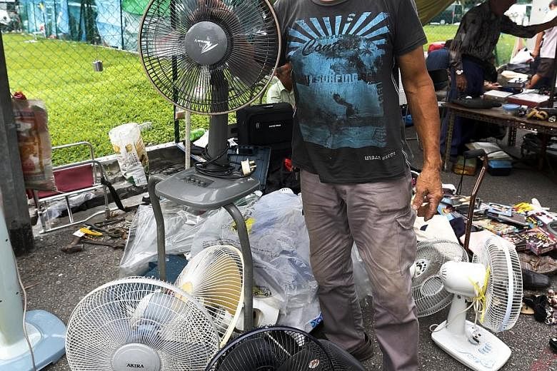 Mr Peter Chou specialises in repairing broken electric fans and selling them for a higher price at the Sungei Road flea market.
