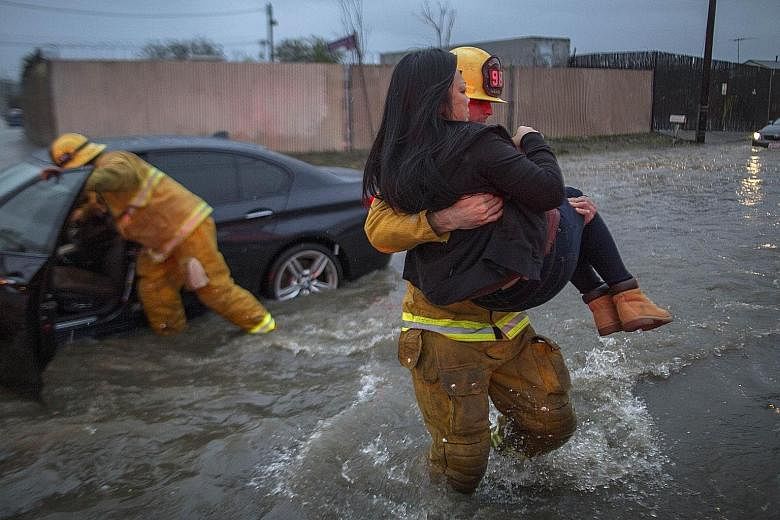Motorists in Sun Valley in Los Angeles left stranded by flash floods on Friday. Flash flood warnings were also issued in many parts of California.