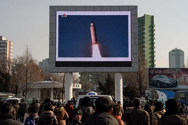 People in Pyongyang watching a public broadcast of the launch of the Pukguksong-2 missile on Feb 12. President Trump wants China to get tougher with North Korea.