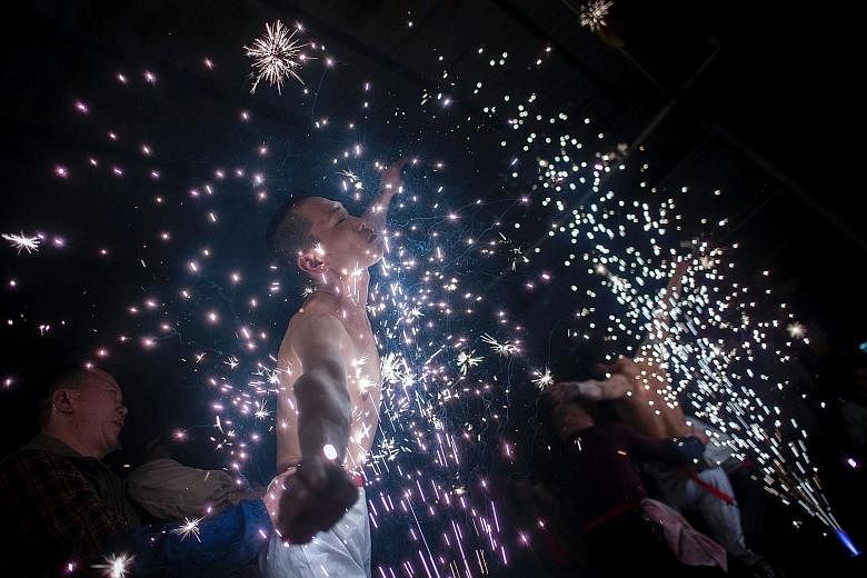Villagers in eastern China have a unique way of washing away the taint of evil spirits - by bathing in a shower of scorching sparks. The ceremony in the village of Fangshan, Fujian province, begins when eight local men selected by village elders don 
