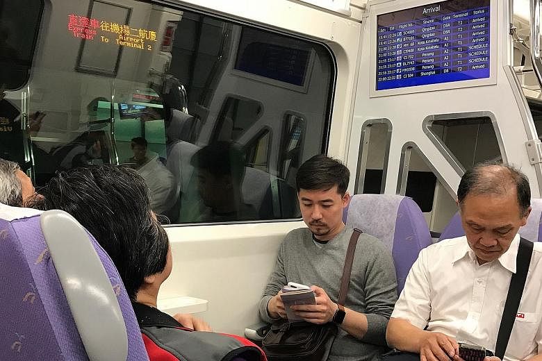 Commuters trying out the express train service from Taoyuan Airport Terminal 2 before its official launch on March 2. The 35-minute direct train ride from the airport to Taipei Main Station in the city costs $7.40.