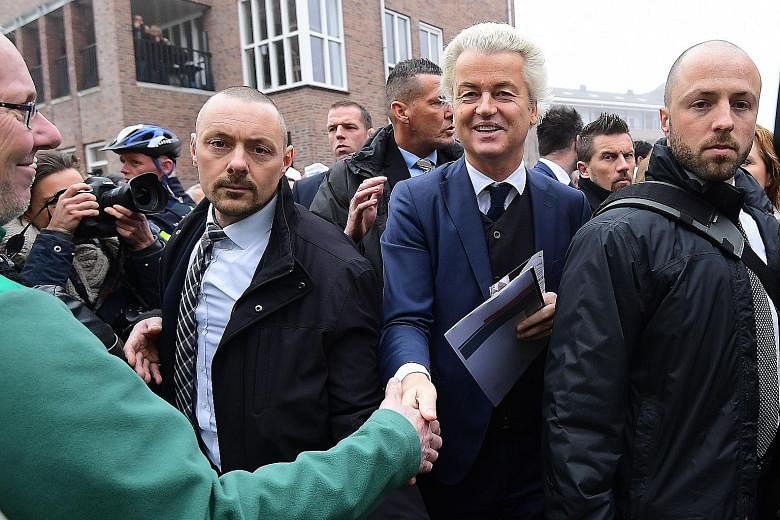 Mr Wilders greeting a supporter in the blue-collar town of Spijkenisse. He has been leading opinion polls ahead of crunch elections on March 15.