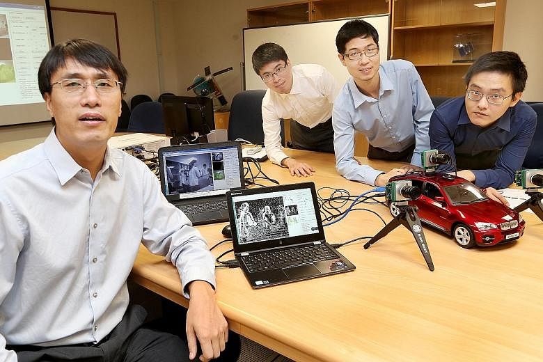 From left: Assistant Professor Chen Shoushun, 40, with researchers Guo Menghan, 28, Li Wan Long, 26, and Yang Wen Lei, 25, and the prototype camera named Celex. The ultra-fast camera mimics the capability of the human eye and can track minute changes