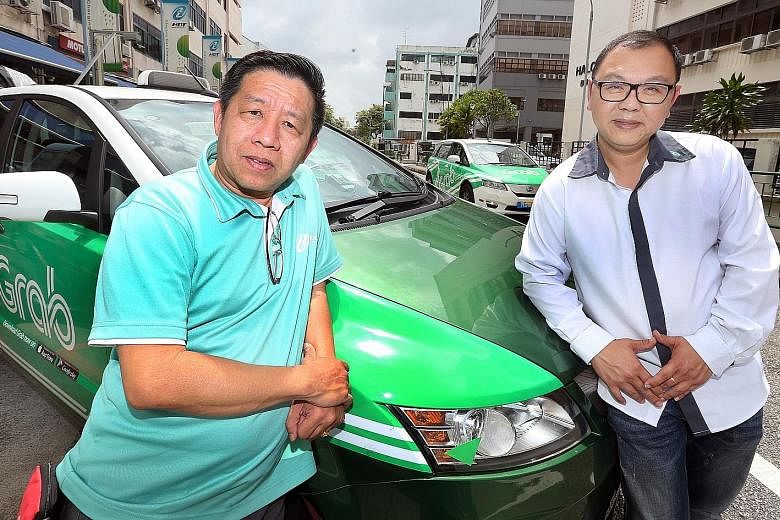 HDT cabbies Michael Ng (far left) and Danny Chia get a basic gross income of $1,900 a month, including CPF contributions.