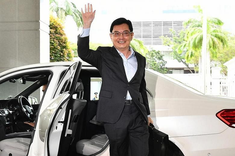 Mr Heng signalling that it was business as usual with a sweeping, confident wave as he arrived at Parliament House to deliver the Budget speech yesterday.