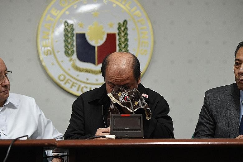 Mr Lascanas wiping his tears yesterday at the news conference as he spoke about crimes allegedly ordered by Mr Duterte.