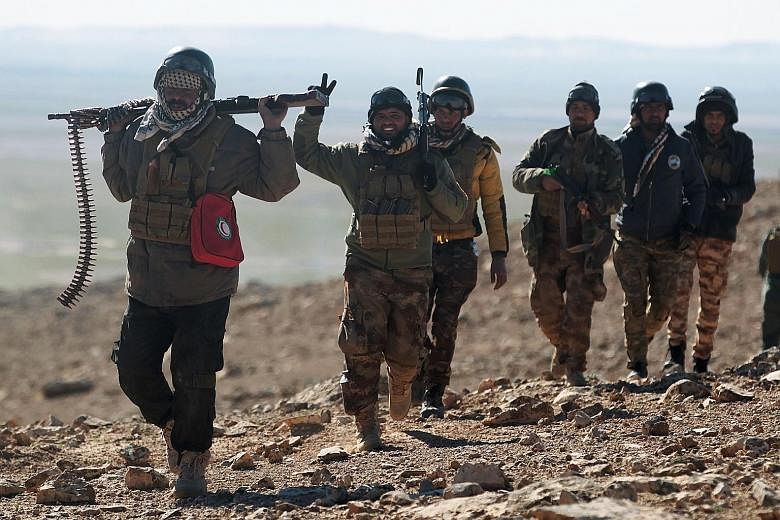 Iraqi forces, supported by paramilitaries, advancing near the village of Sheikh Younis, south of Mosul, after the offensive to retake the western side of the city from ISIS on Sunday. US Defence Secretary Mr Mattis said US Special Forces will not get