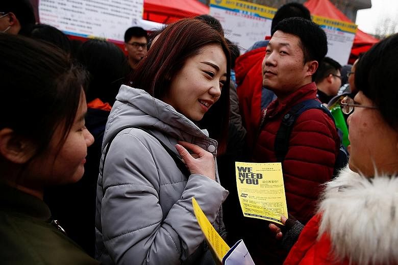 A recruiter handing out a flier to a job seeker in Hebei province. Millennials in China are warming to short-term employment.