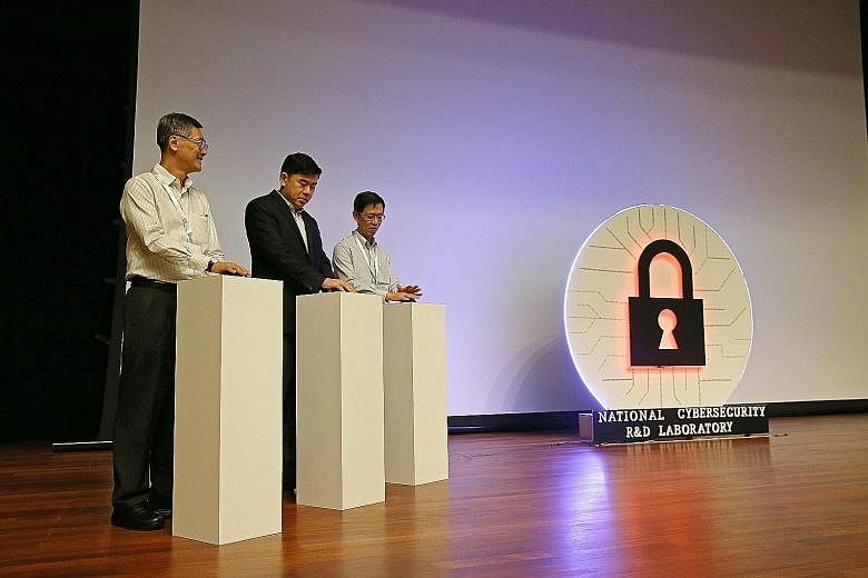 (From left) NUS provost Tan Eng Chye, Permanent Secretary for Communications and Information Gabriel Lim and National Cybersecurity R&D Laboratory governing board chairman Quek Gim Pew at the launch yesterday.
