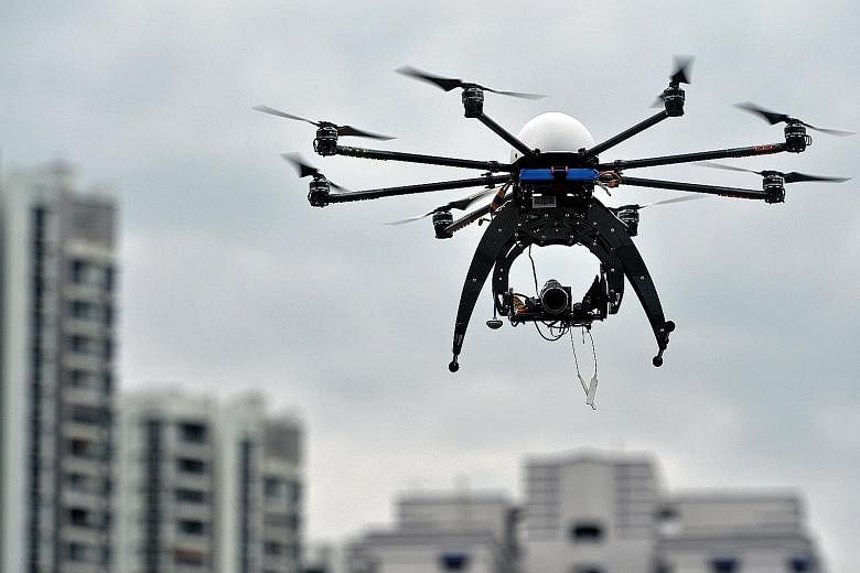 A drone being used as part of an inter-agency effort to inspect construction sites in February last year. Other examples of the use of such vehicles in Singapore include the Urban Redevelopment Authority's use of drones to capture aerial images and v