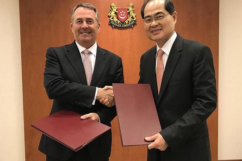 Mr Lim and Dr Fox at the signing of the renewed bilateral economic and business partnership agreement yesterday.