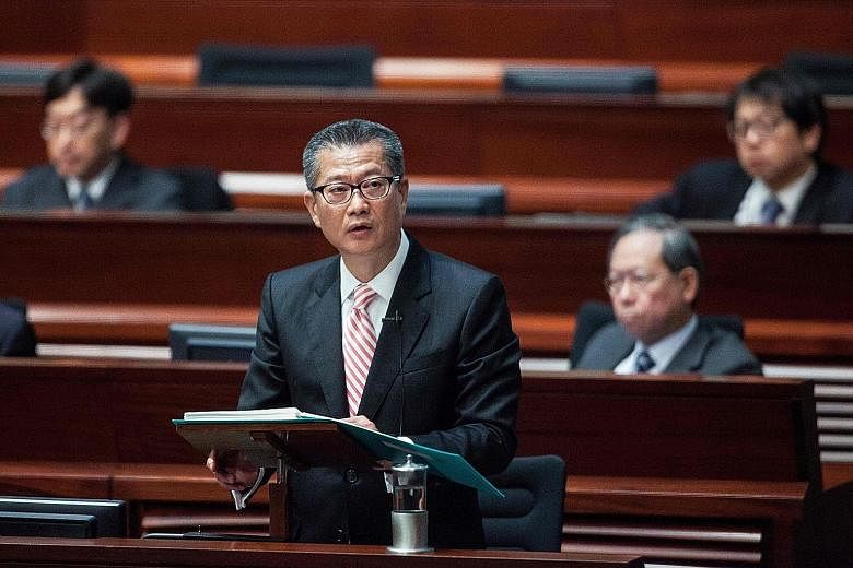 Mr Chan delivering the 2017 Hong Kong budget speech at the Legislative Council yesterday. With a surplus of HK$92.8 billion (S$17 billion), the former development minister announced billions in tax cuts and poverty relief in a budget hailed as "forwa