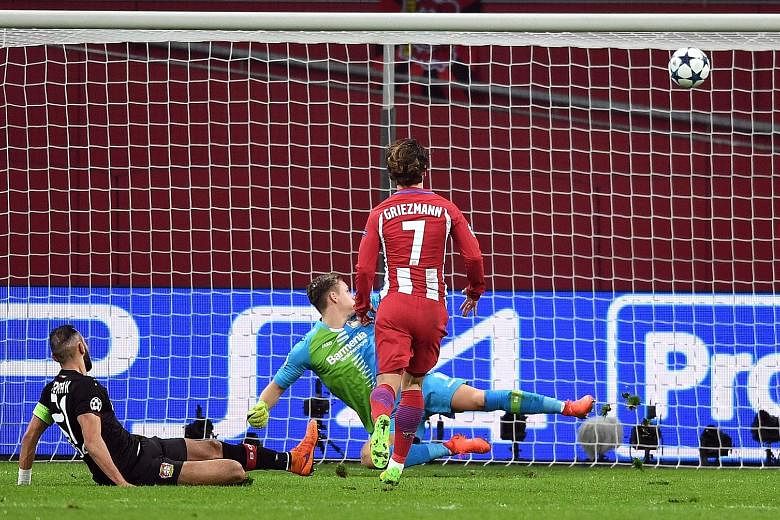 Antoine Griezmann watching his shot hit the back of the net via the crossbar to put Atletico two goals up in their 4-2 defeat of Bayer Leverkusen, as the beaten Bernd Leno can only watch on helplessly.
