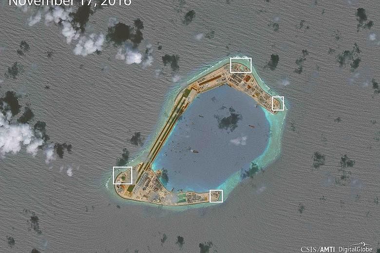 A satellite image showing what appear to be anti-aircraft guns and close-in weapons systems on Subi Reef, part of the Spratly Islands in the South China Sea.