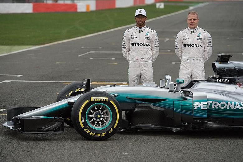 Mercedes drivers Lewis Hamilton (left) and Valtteri Bottas posing by the Mercedes W08, the team's new car for the season starting on March 26. Testing will start in Barcelona on Monday and team boss Toto Wolff has said that Mercedes are "buzzing with