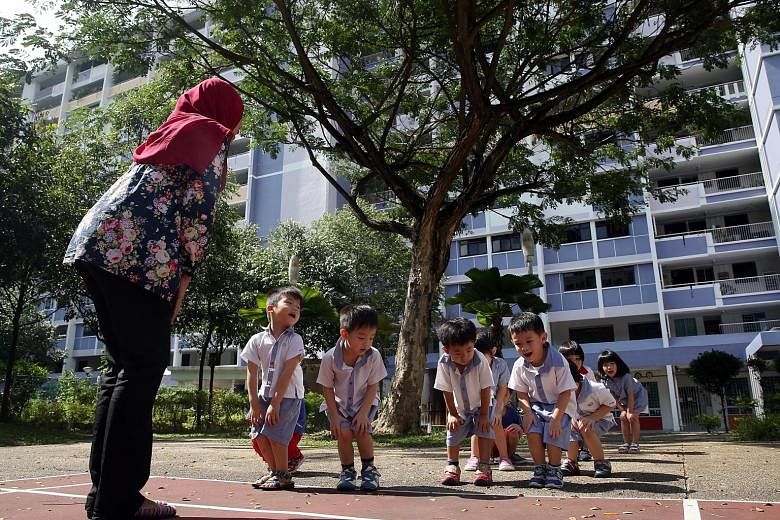 Teacher Salina Kasimon, 32, from PCF Sparkletots Preschool@Fengshan leading her nursery class in exercise. Full-day pre-school programmes will have to devote at least an hour to physical activity daily.