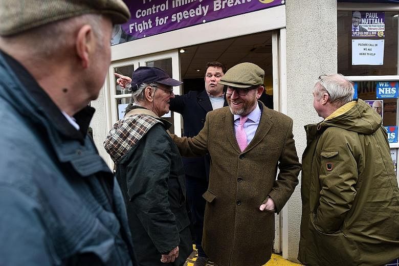 Ukip leader Paul Nuttall (centre) campaigning in Stoke on Wednesday. Meanwhile, the ruling Conservatives are gunning for a separate Labour-held seat.