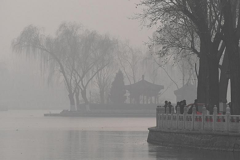 Smog blankets a lake in Beijing in January. Despite the Chinese government's stringent rules on pollution control and emissions, improvement in air quality continues to fall short of public expectations, especially in the north of the country, which 