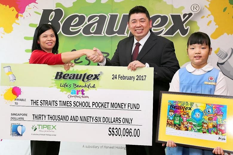 Ms Tan of The Straits Times School Pocket Money Fund receiving the cheque yesterday from Tipex's Mr Sim at Tipex's office. Also present was Keming Primary's Rachel Chng, showing her winning entry.