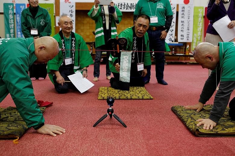 More than 30 men gathered at a hot spring facility in Tsuruta City, Japan, on Wednesday to show off their hairless heads and have fun. Members of the city's Bald Men Club took turns competing in a unique game of tug-of-war by sticking a suction cup, 