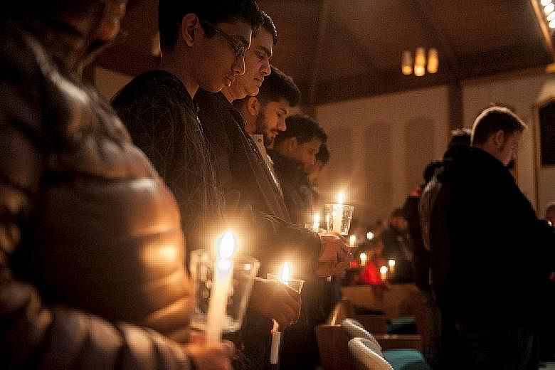 A vigil being held for Mr Kuchibhotla (top left) at First Baptist Church in Olathe, Kansas, on Friday. Navy veteran Adam Purinton (left) reportedly opened fire while screaming at the victim and his friend Alok Madasani to "get out of my country".