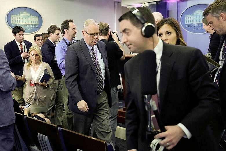 Journalists leaving after the White House excluded several major news groups from an off-camera briefing on Friday.