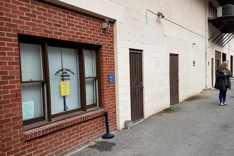 One of the two methadone treatment centres for heroin addicts in Cumberland, Maryland (left) and a Trump sign displayed in the area (above). President Trump has promised to expand "drug courts" where addicts are closely supervised, and to equip first