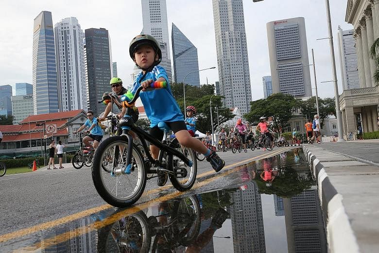 A young cyclist getting a taste of riding on roads free of vehicular traffic yesterday, as part of Car-Free Sunday in the Civic District. In conjunction with the event, the Land Transport Authority gave a preview of the 90-minute Safe Riding Programm
