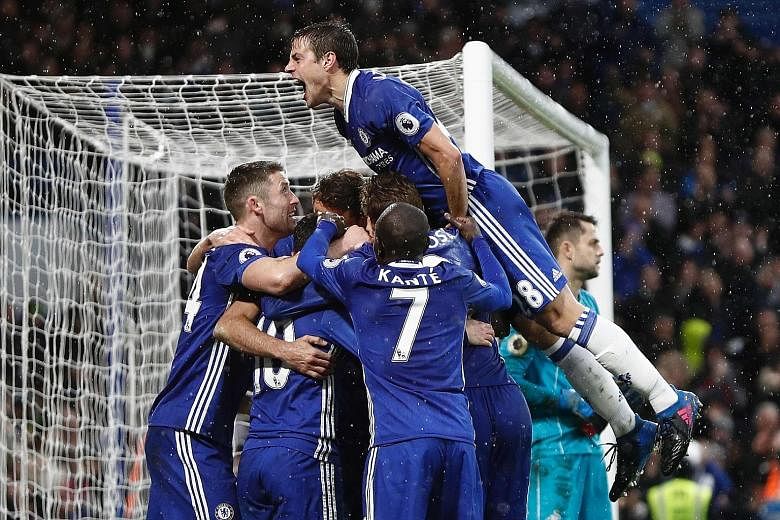 Chelsea players celebrating Diego Costa's 84th minute goal, which secured a 3-1 win over Swansea. The Blues next go to West Ham in the Premier League.