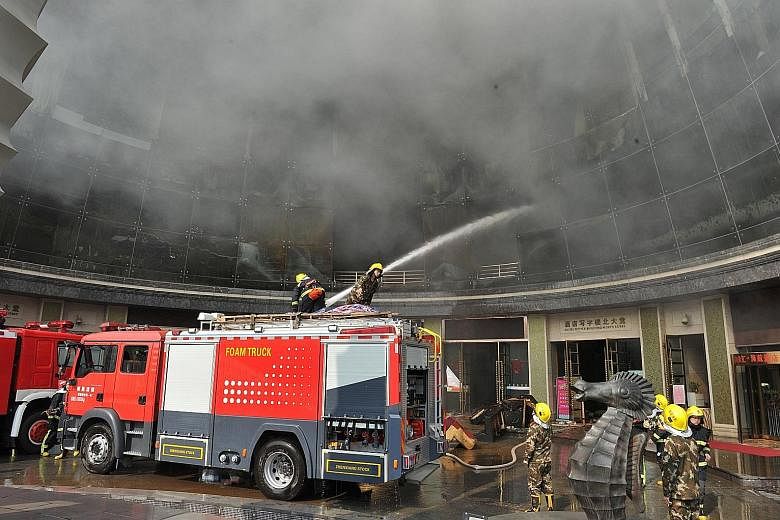 Firemen fighting a blaze at HNA Platinum Mix Hotel in Nanchang, in China's Jiangxi province, on Saturday. The authorities have detained 24 people following the fire, which was set off by unsafe welding and cutting work, state media said yesterday. Ni