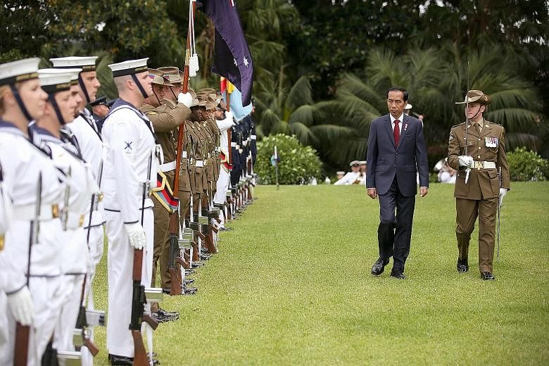 Indonesia's President Joko inspecting a guard of honour during his welcome to Australia yesterday. He told the media that a "robust relationship" between the countries is possible when both "have respect for each other's territorial integrity, non-in