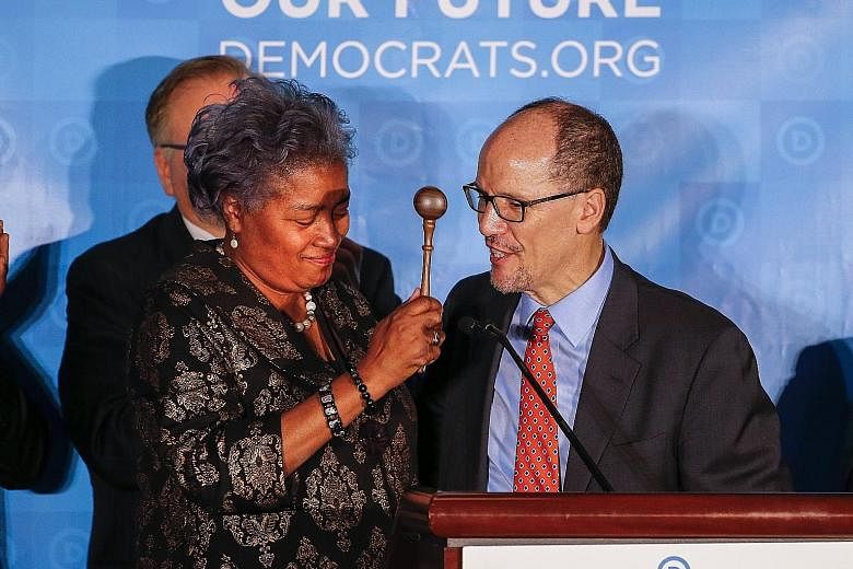 Interim chairman Donna Brazile handing the gavel to newly elected Democratic National Committee chairman Tom Perez during the DNC Winter Meeting in Atlanta, Georgia, on Saturday.