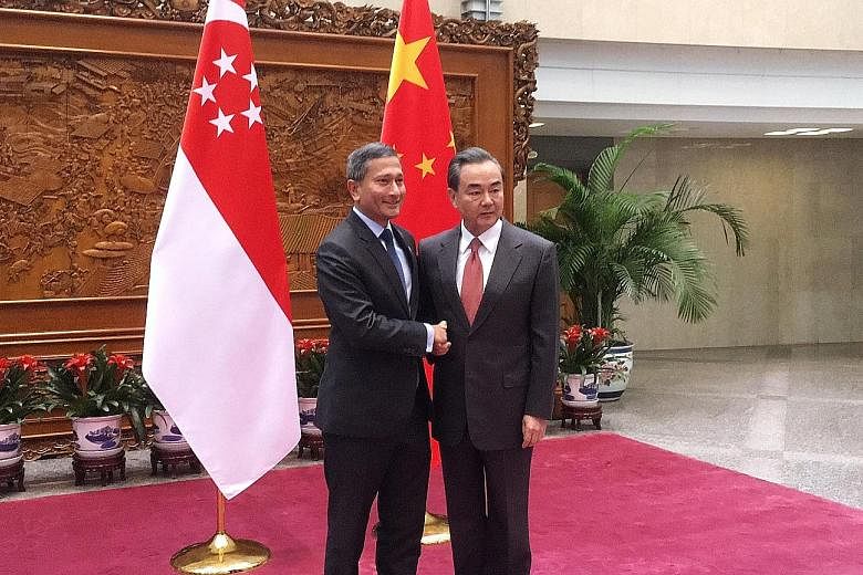 Foreign ministers Dr Balakrishnan and Mr Wang meeting in Beijing yesterday on the sidelines of the Joint Council for Bilateral Cooperation.