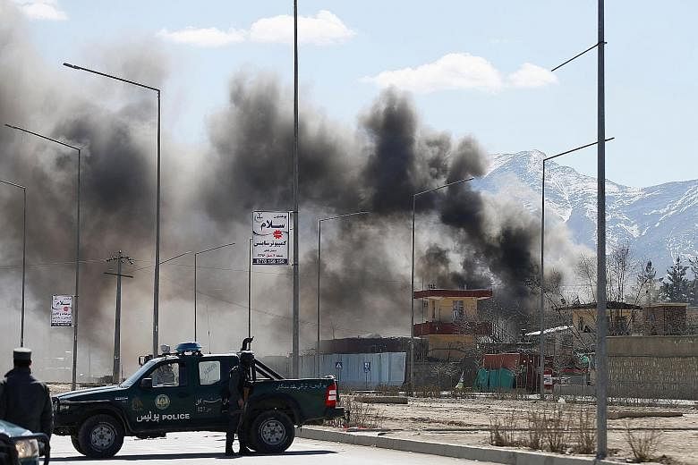 The site of a blast and gunfire between the Taleban and Afghan forces in Police District 6, in Kabul, yesterday. One militant was barricaded inside the police HQ there.
