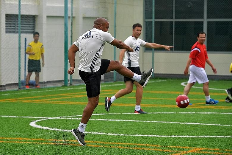 Former Manchester United players Quinton Fortune and Ronny Johnsen joined employees of DHL Express Singapore for a friendly futsal match yesterday. They were in town to promote a brand of wine and also helped officially open the new futsal court at D