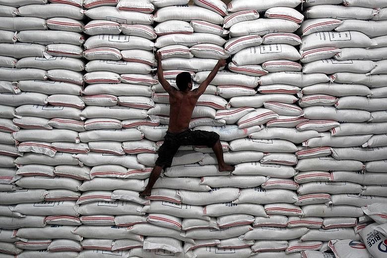 A National Food Authority warehouse stacked with bags of rice in Bicutan, in the Philippines. The South-east Asian country, which showed the fastest economic expansion last year, may be the first in the region to tighten monetary policy this year, sa