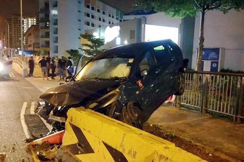 The driver of this car, reportedly a private-hire driver, escaped serious injury despite the damage to the car, which ended up between a roadside barrier and a walkway railing. Bystanders helped pull him out.