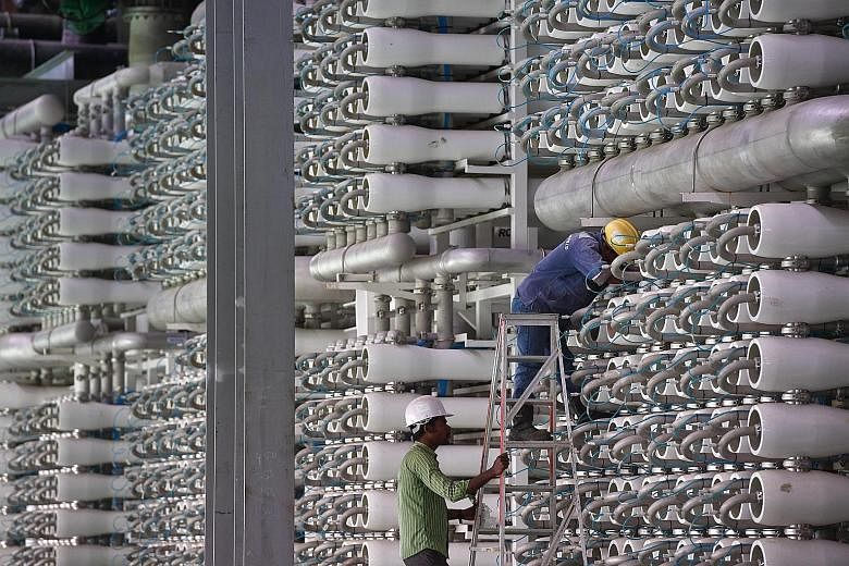 A worker checking the equipment at a Newater plant in Changi. PUB intends to invest $4 billion on additional water infrastructure in the next five years.
