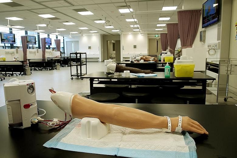 Equipped with prosthetic arms and other cutting-edge facilities, the practical skills laboratory at the Centre for Clinical Simulation gives students the opportunity to hone their skills. PhD student Divya Gunaseelan, 27, at one of the new facility's