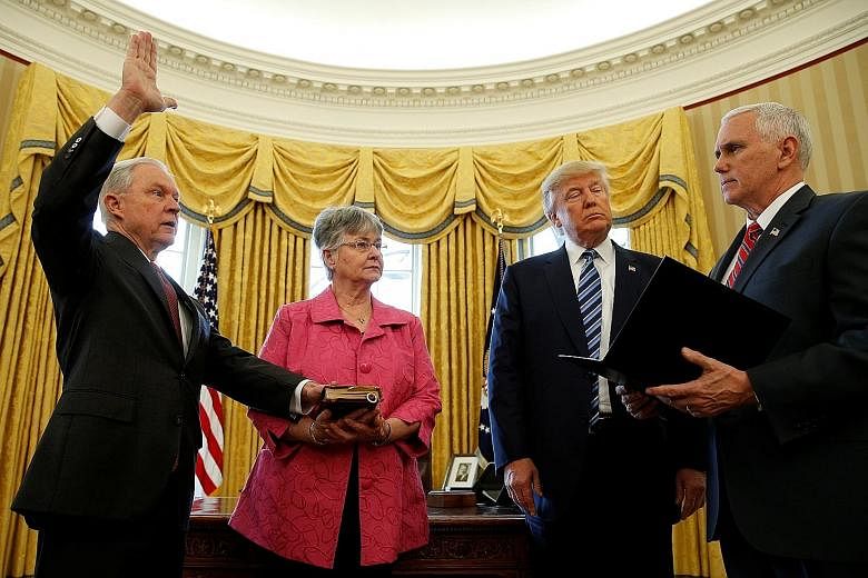Mr Sessions being sworn in on Feb 9 by Vice-President Mike Pence, with Mrs Mary Sessions holding the Bible and President Trump looking on.