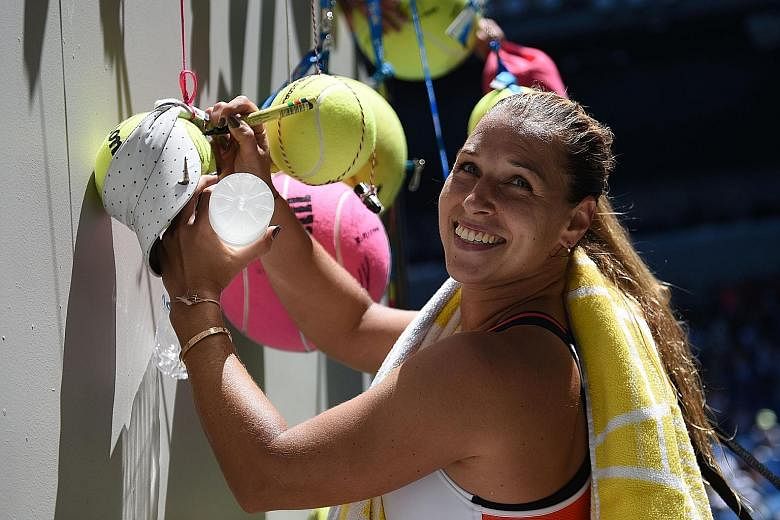 Slovakia's Dominika Cibulkova signing autographs at the Australian Open. The 27-year-old lost in the third round at Melbourne Park and is learning how to deal with the pressure of being the world No. 5.