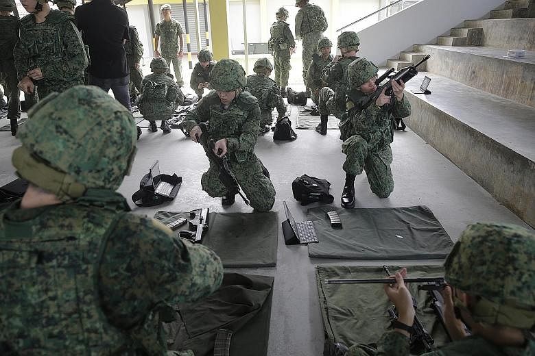 Recruits undergoing weapon- handling practice at the SAF Basic Military Training Centre on Pulau Tekong. In all, more than 96 per cent of full-time national servicemen who enlist from this January will receive the Workforce Skills Qualification annua