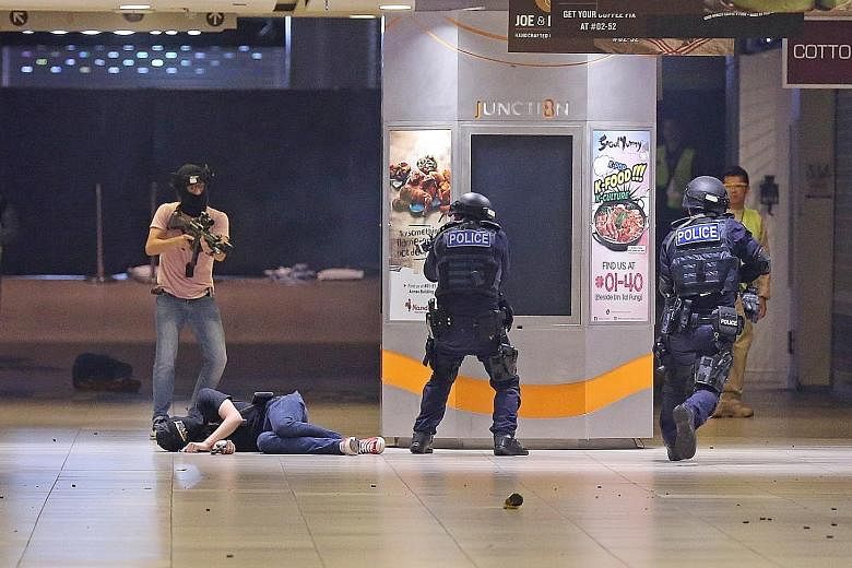 A "terrorist" in a shoot-out with police during a counter-terror exercise in Bishan's Junction 8 mall last October. New large-scale commercial buildings will be required to undergo a review at the design stage to determine what security measures are 