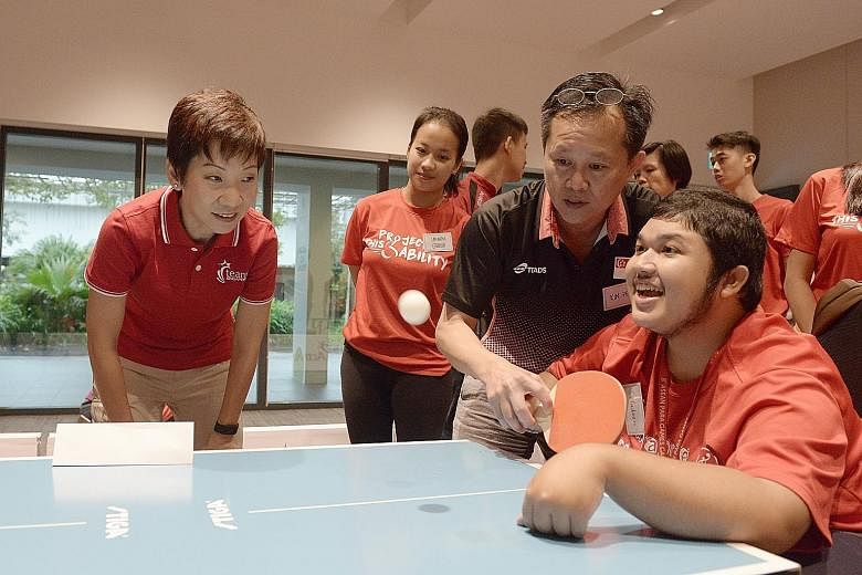 Minister for Culture, Community and Youth Grace Fu cheering Mr Muhd Saifudeen on as he took part in para table tennis at the event yesterday.