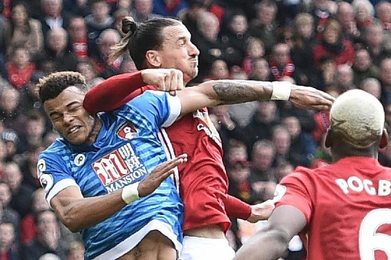 The contentious moment of the match, as Man United striker Zlatan Ibrahimovic (left) seemingly lands an elbow on the head of Bournemouth defender Tyrone Mings during their 1-1 Premier League draw at Old Trafford yesterday.
